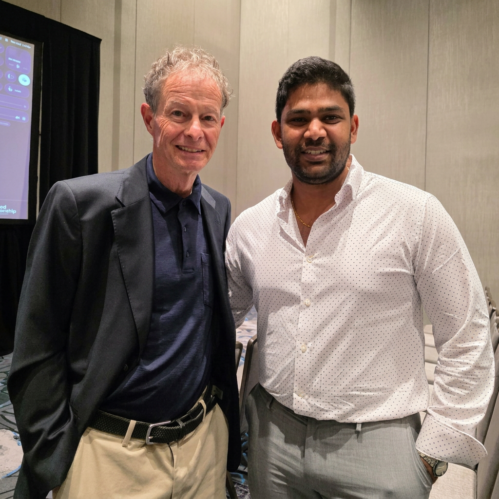 Vik Guttikonda with John Mackey, founder of Whole Foods Market, at a conference