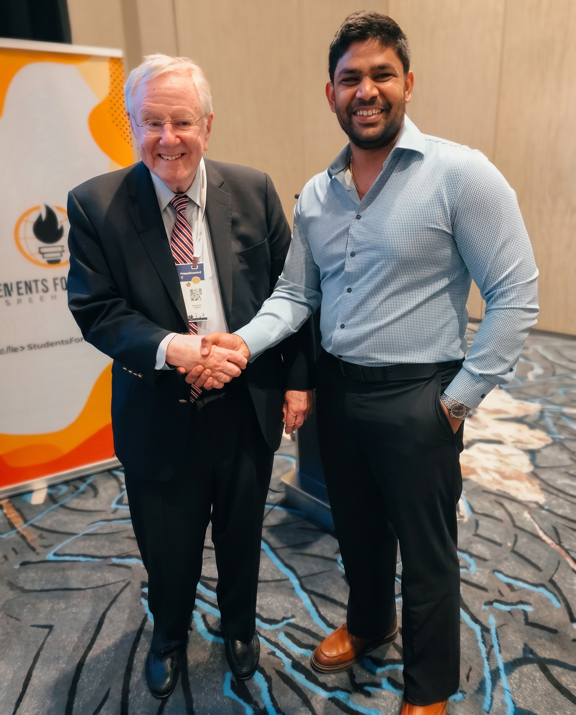 Vik Guttikonda with Steve Forbes at FreedomFest, discussing enterprise AI transformation